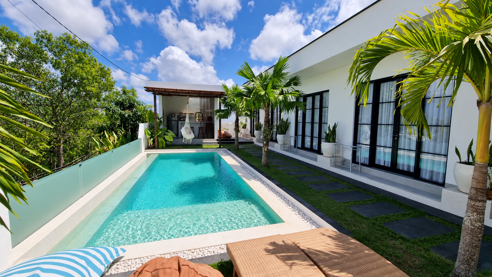 Sari Hills Bali pool with the kitchen pavilion and guest rooms in the tropical garden